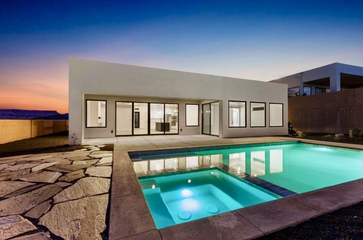 Modern St. George home with a pool at twilight